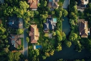 Aerial view of upscale residential neighborhood with lush greenery and waterway. photo