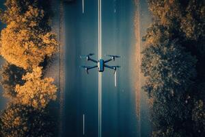 Drone flying over autumnal road. photo