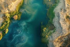 Aerial view of a river flowing through a desert landscape. photo