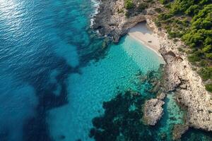 Secluded cove with crystal clear turquoise water, aerial view. photo