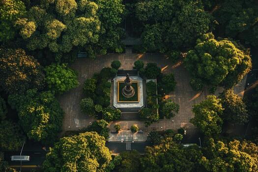Aerial view of a statue in a lush green park. photo