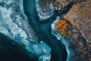 Aerial view of a frozen river flowing through a landscape. photo