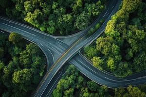 Aerial view of highway interchange surrounded by lush green forest. photo