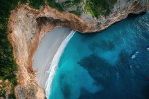 Secluded cove with white sand beach and turquoise water, aerial view. photo