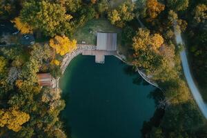 Aerial view of a serene lake surrounded by autumn foliage. photo