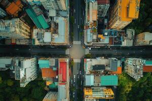 Aerial view of city intersection, roads, buildings, and green spaces. photo