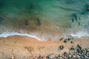 Aerial view of ocean waves lapping sandy beach. photo