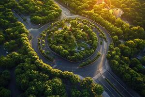 Aerial view of a circular road surrounded by lush greenery at sunset. photo
