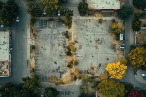 Aerial view of an empty, overgrown parking lot in a residential area. photo