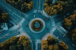 Aerial view of a roundabout intersection surrounded by lush greenery. photo