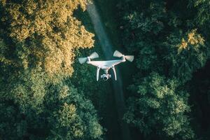 Drone flying over forest path. photo