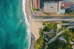 Aerial view of ocean meeting city coast. photo