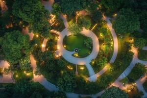 Aerial view of a park at night with illuminated pathways. photo