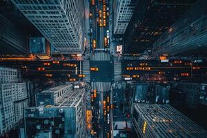 Aerial view of city intersection at night, showing skyscrapers and traffic. photo