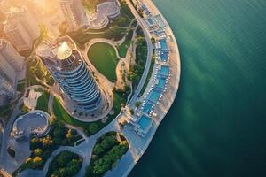 Aerial view of modern cityscape with waterfront park and buildings at sunset. photo