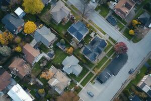 Aerial view of suburban houses, streets, and yards in autumn. photo