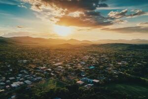Aerial view of town at sunset, mountains in background. photo