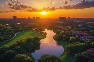 Sunset over golf course and city skyline. photo