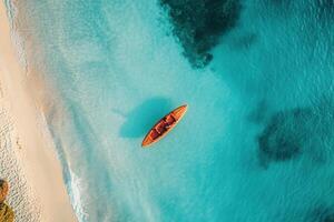 Aerial view of a wooden boat in turquoise water near a sandy beach. photo
