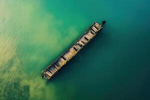 Sunken shipwreck in teal water. photo