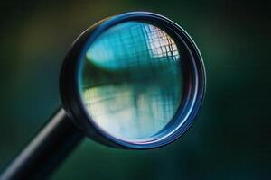 Close-up of a magnifying glass lens reflecting a blurred background. photo