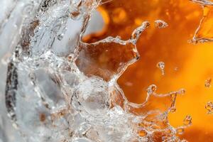Abstract close-up of amber liquid splashing against ice. photo