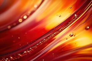 Abstract close-up of red and orange liquid with bubbles, swirling patterns. photo
