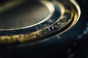Close-up of a metallic ring with etched details, showing texture and depth of field. photo