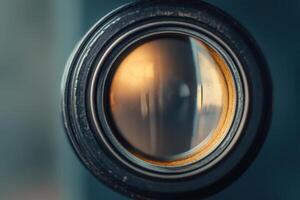 Close-up of a vintage camera lens with a warm light reflection. photo
