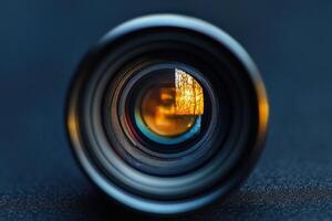 Close-up of camera lens with autumn scene reflected. photo