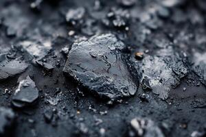 Close-up of dark, oily rocks on a beach. photo