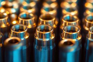 Close-up of shiny metal cylinders, precision-engineered parts in a factory setting. photo
