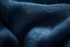 Close-up of textured blue fabric, showing detailed weave and folds. photo