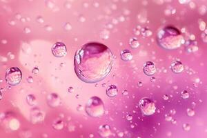 Close-up of water droplets on a pink surface, reflecting light and creating a bokeh effect. photo