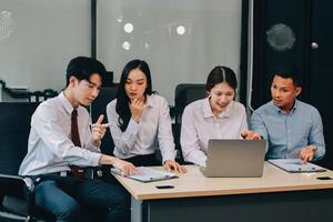 Entrepreneurs and business people conference in modern meeting room, happy multiracial coworkers have fun cooperating working together at office meeting, asian teamwork concept photo