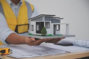 Architects, engineers, contractors working in the office with blueprints, inspection engineers Work analysis for architectural plan, construction project sketch, focus, business construction concept. photo