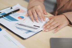 business documents businessman check legal document review Prepare documents or analysis reports, tax items, accounting documents, data contracts, office partner agreements. photo