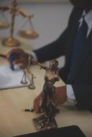 Judge gavel and miniature car symbolize auction or court case against driver who has accident and receiving vehicle insurance payment be on table in front of hands of lawyers. Selective focus photo