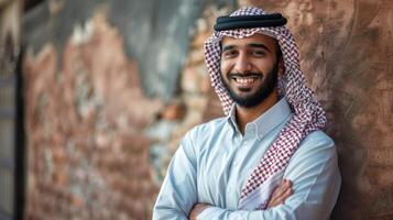 Arabic man with a beard standing in front of a brick wall photo