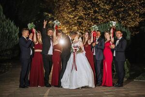 A group of people are posing for a picture with a bride and groom in the center photo