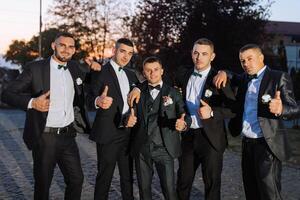 A group of men in suits are posing for a picture photo
