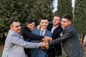 A group of men are hugging each other in a park photo