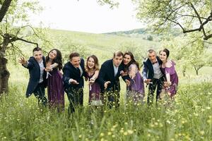 A group of people posing for a photo in a field