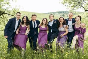 A group of people are posing for a picture in a field photo