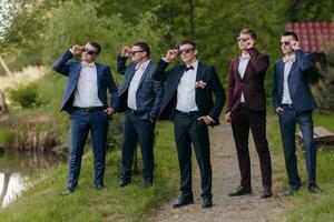 A group of men in suits and ties are posing for a photo
