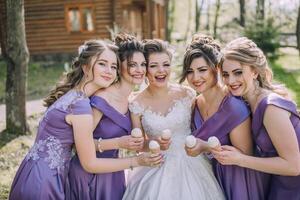 A group of women are posing for a picture with ice cream and smiling photo
