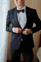 A man in a suit is getting ready to go out photo