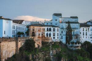 Evening View of Ronda's Whitewashed Buildings on Cliff Edge photo