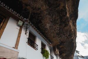 Whitewashed Buildings Under Rock Formations in Setenil De Las Bodegas photo