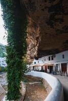 Whitewashed Buildings Under Rock Formations in Setenil De Las Bodegas photo